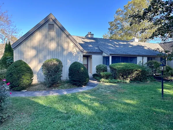 a backyard of a house with plants and outdoor seating