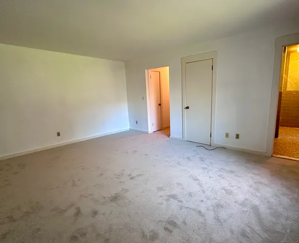 a bathroom with a granite countertop sink a toilet and shower