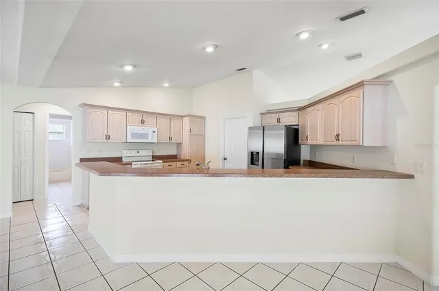 a kitchen with white cabinets and white appliances