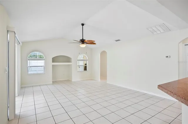 a kitchen with a sink window and cabinets