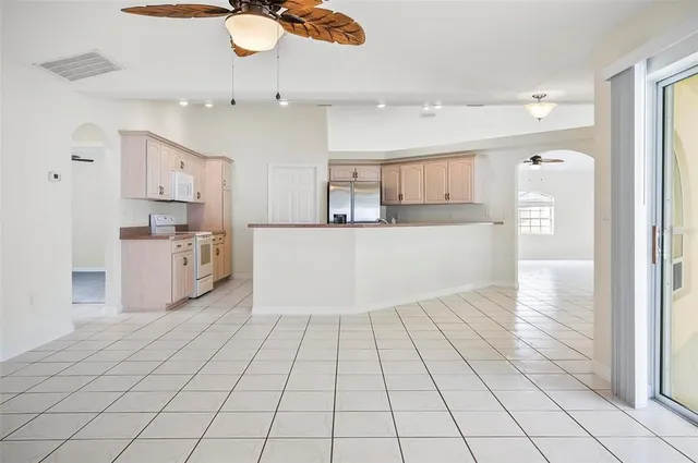 a kitchen with white cabinets and white appliances