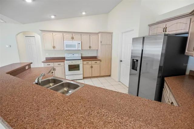 a spacious bathroom with a granite countertop sink mirror and bathtub
