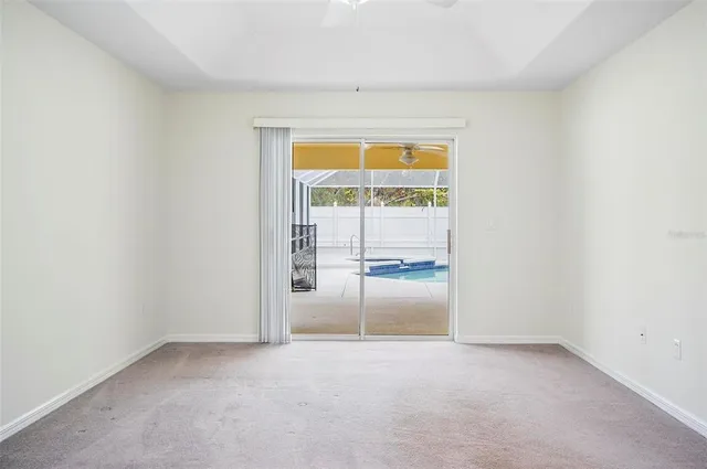 an empty room with a chandelier fan