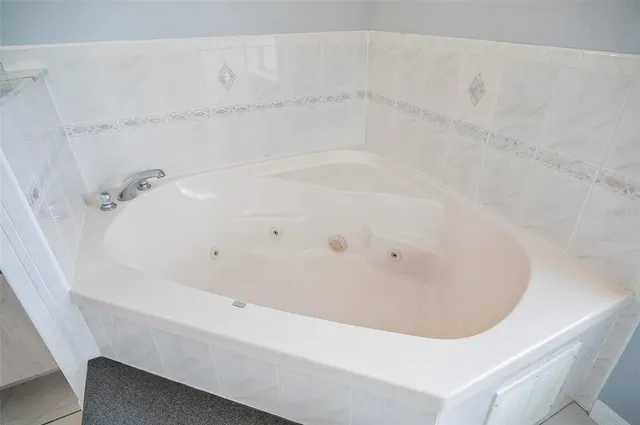 an empty room with a chandelier fan