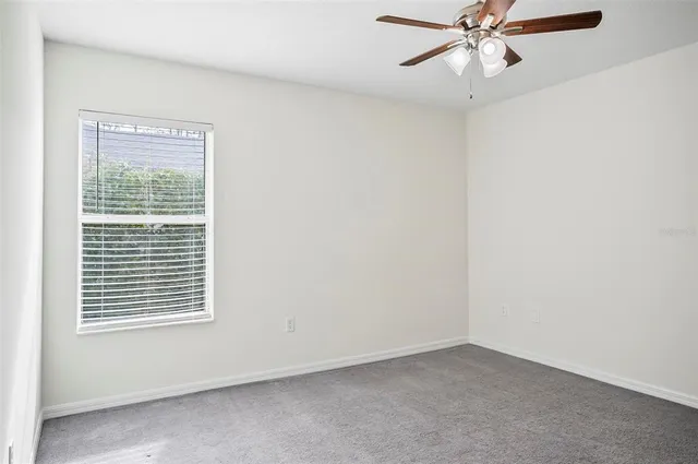 a view of a kitchen with wooden floor and a window