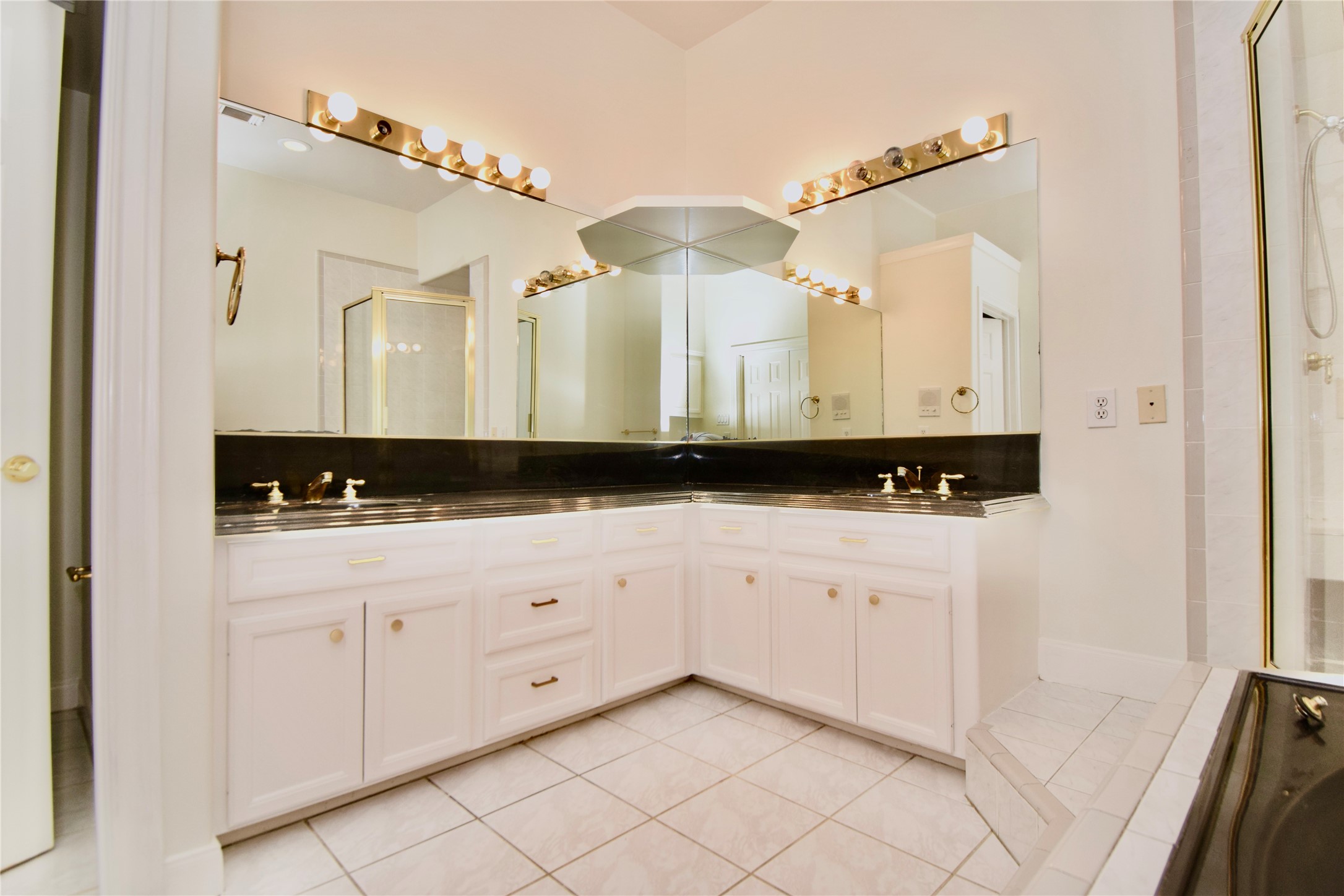 2024 Welch Street Houston, TX 77019 - Photo 9 of 18 a bathroom with a sink and a mirror