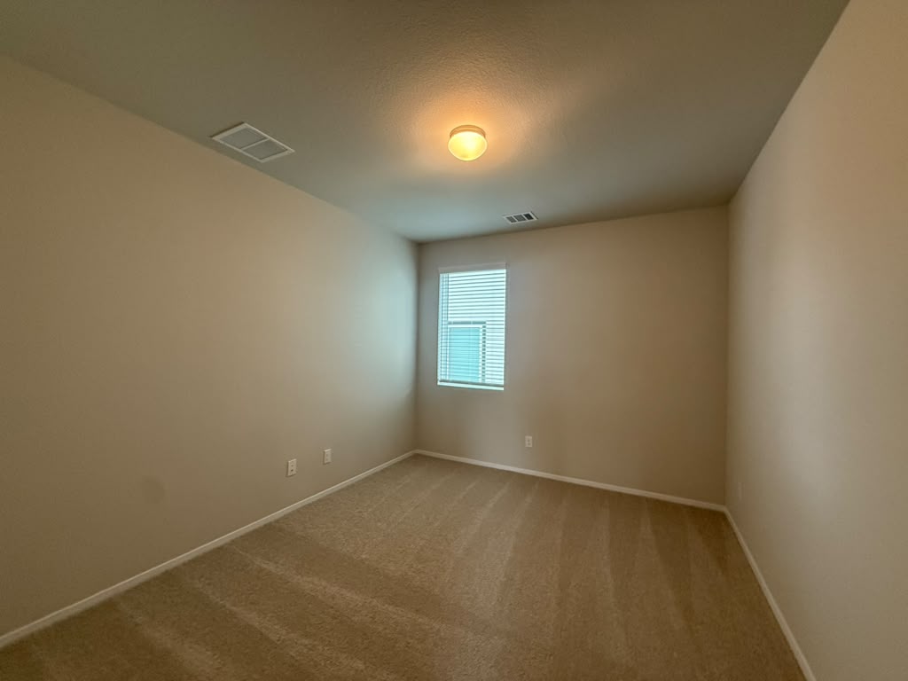 2601 Foss Road Manor, TX 78653 - Photo 11 of 40 Neutral walls and plush carpeting anchor this versatile bedroom space.