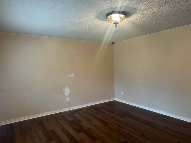 a view of a room with wooden floor