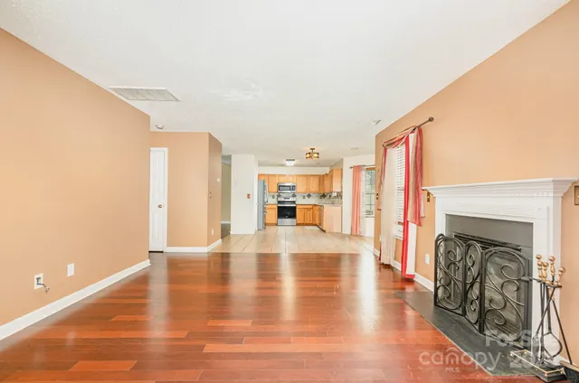 a view of a living room with a fireplace