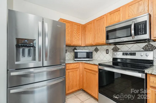 a kitchen with stainless steel appliances and cabinets