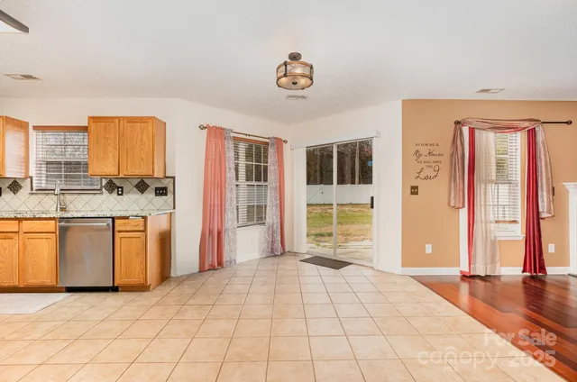 a view of a kitchen with a sink and cabinets