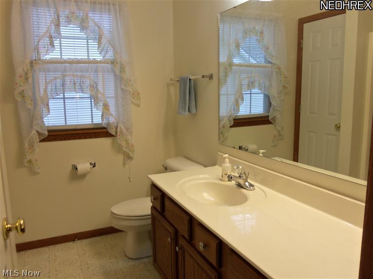 210 Birch Road Painesville, OH 44077 - Photo 14 of 25 YOU WILL ENJOY THE CONVENIENCE OF THE ATTACHED BATH WITH A LARGE VANITY AND EXTRA STORAGE.