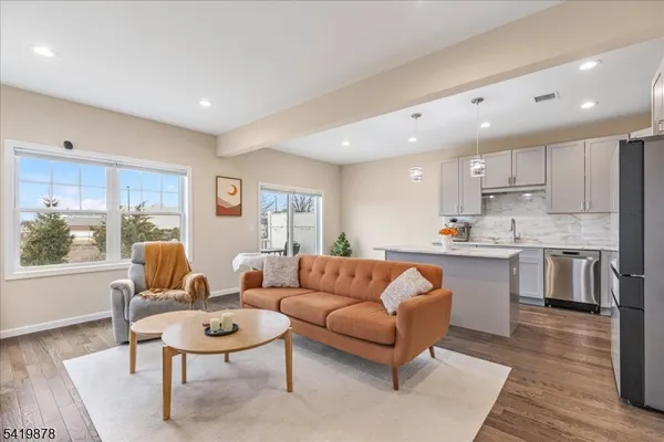 a living room with kitchen island furniture and a wooden floor