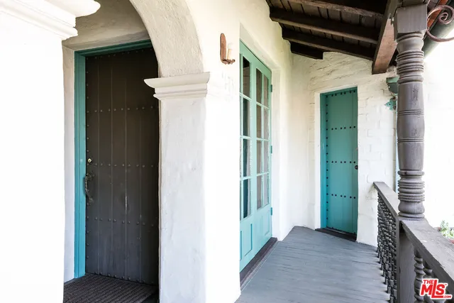 a view of a hallway with wooden floor and entryway