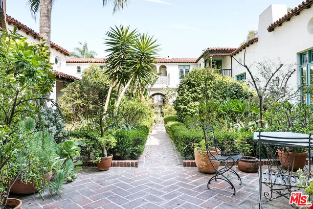 a view of house with backyard and sitting area