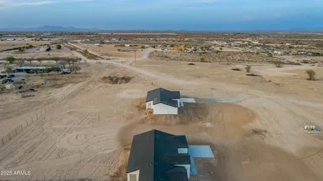 an aerial view of a house with a yard and lake view