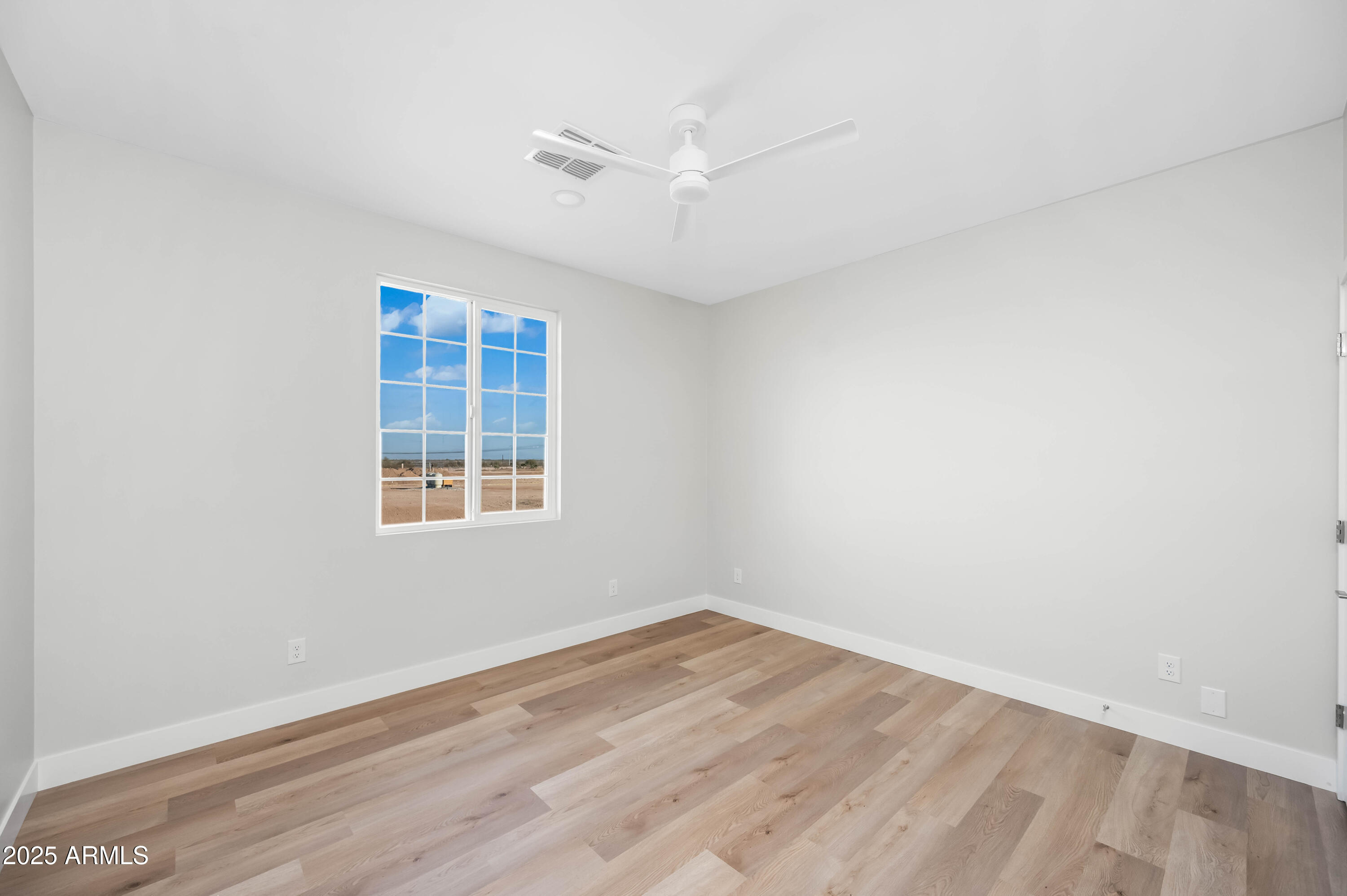 2103 Hassayampa Road Tonopah, AZ 85354 - Photo 19 of 37 wooden floor in an empty room with a window