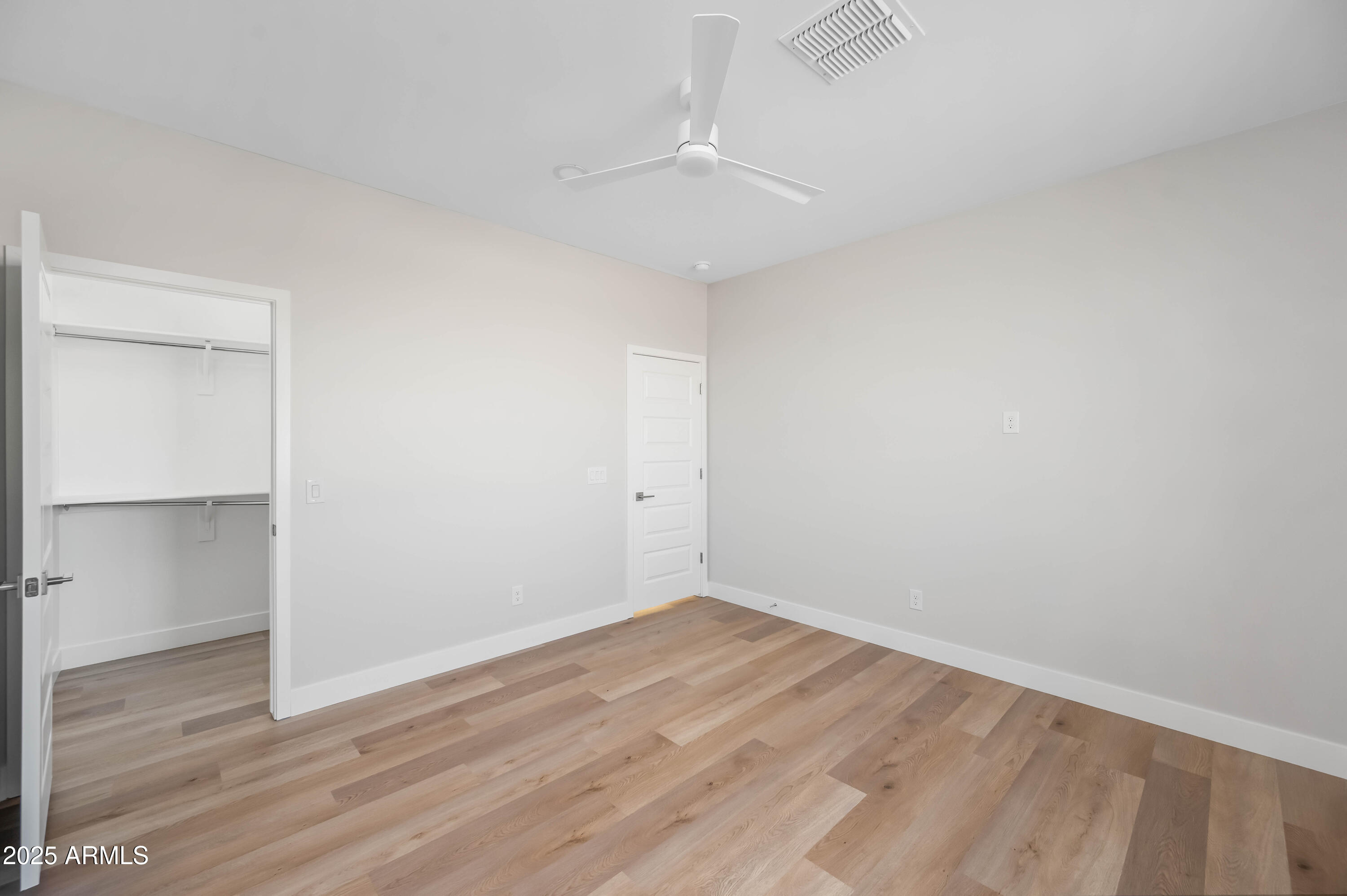 2103 Hassayampa Road Tonopah, AZ 85354 - Photo 20 of 37 an empty room with wooden floor and closet