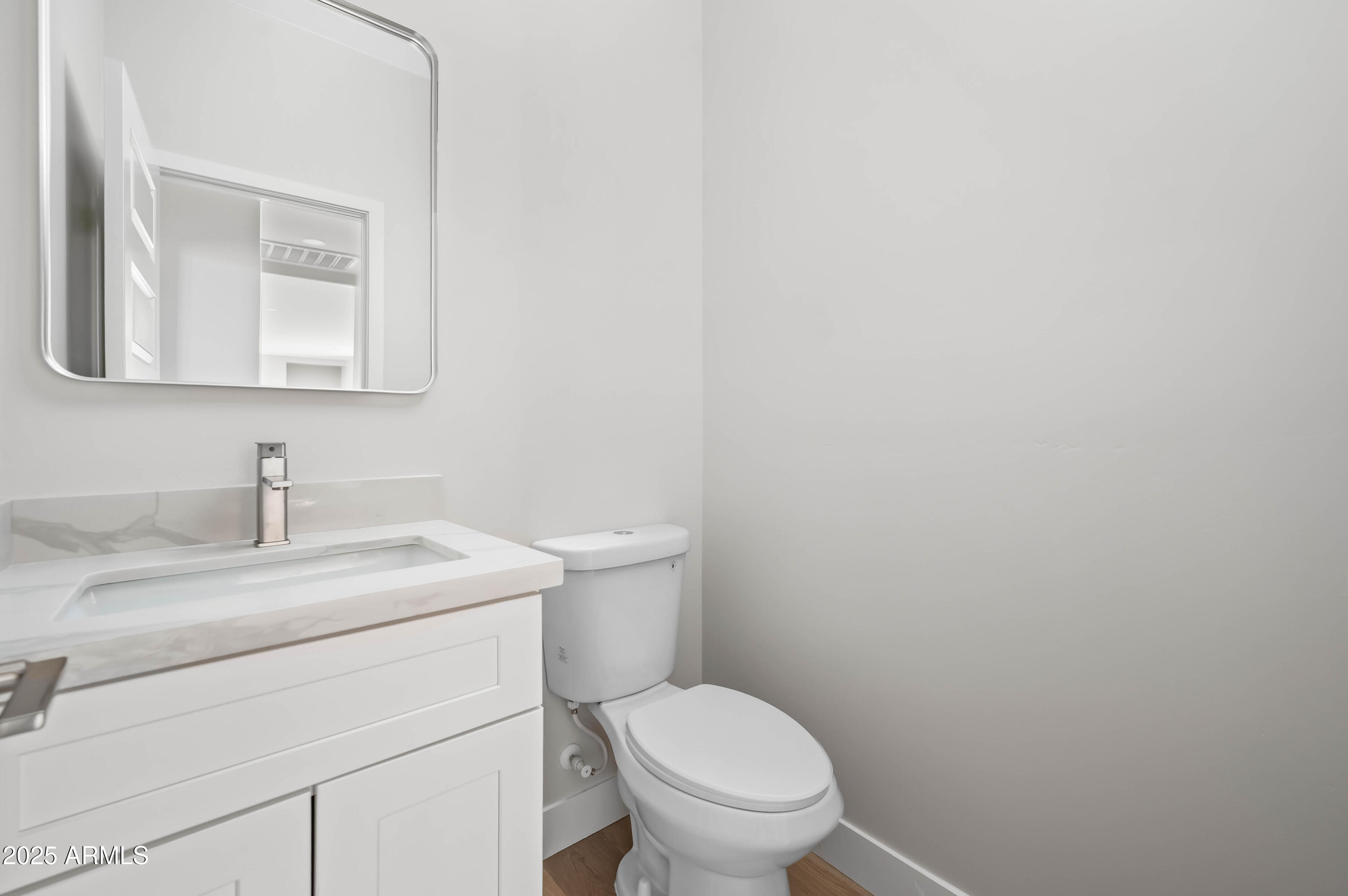 2103 Hassayampa Road Tonopah, AZ 85354 - Photo 23 of 37 a bathroom with a toilet sink vanity and mirror