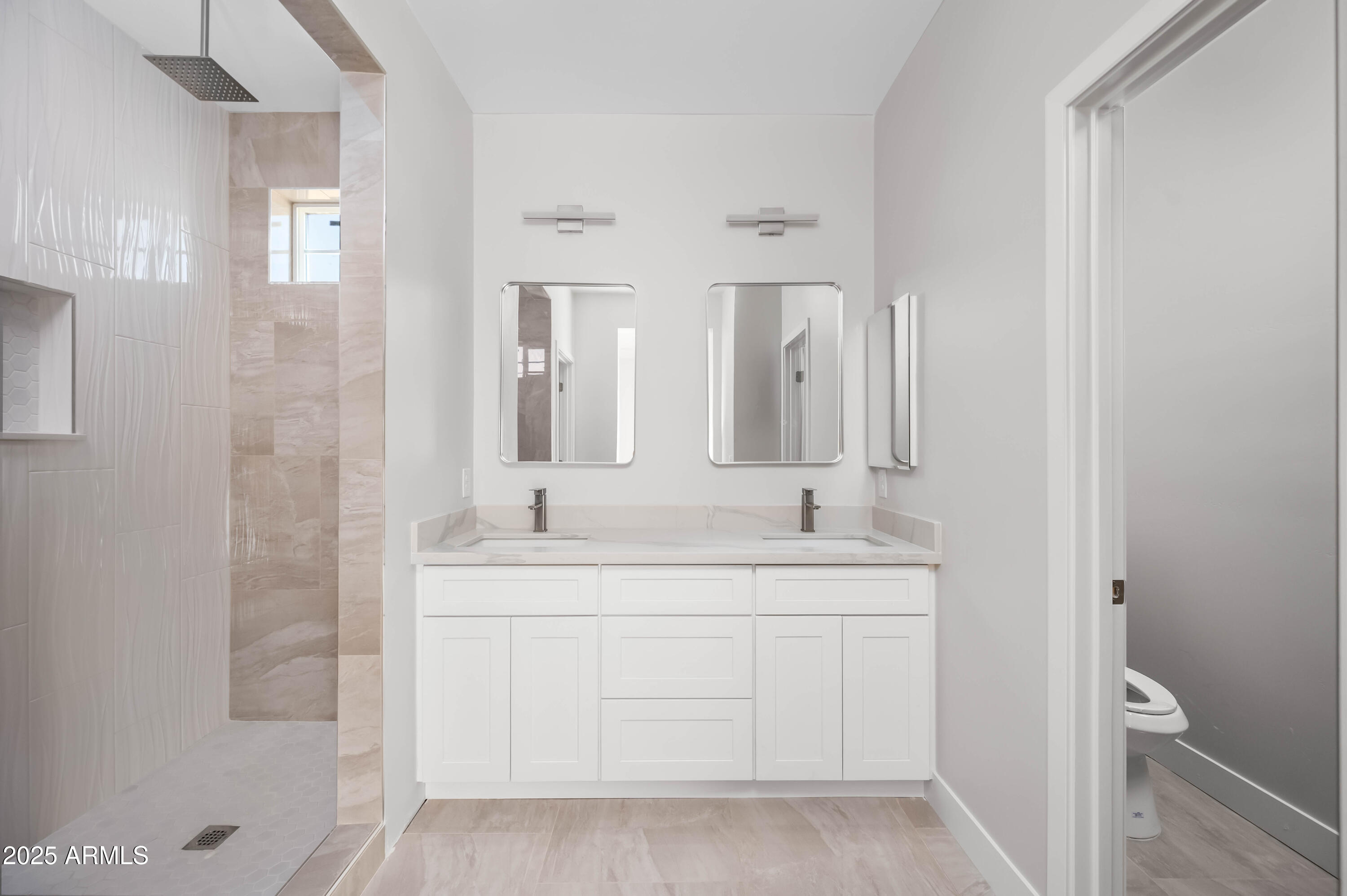 2103 Hassayampa Road Tonopah, AZ 85354 - Photo 27 of 37 a bathroom with a double vanity sink and mirror with shower