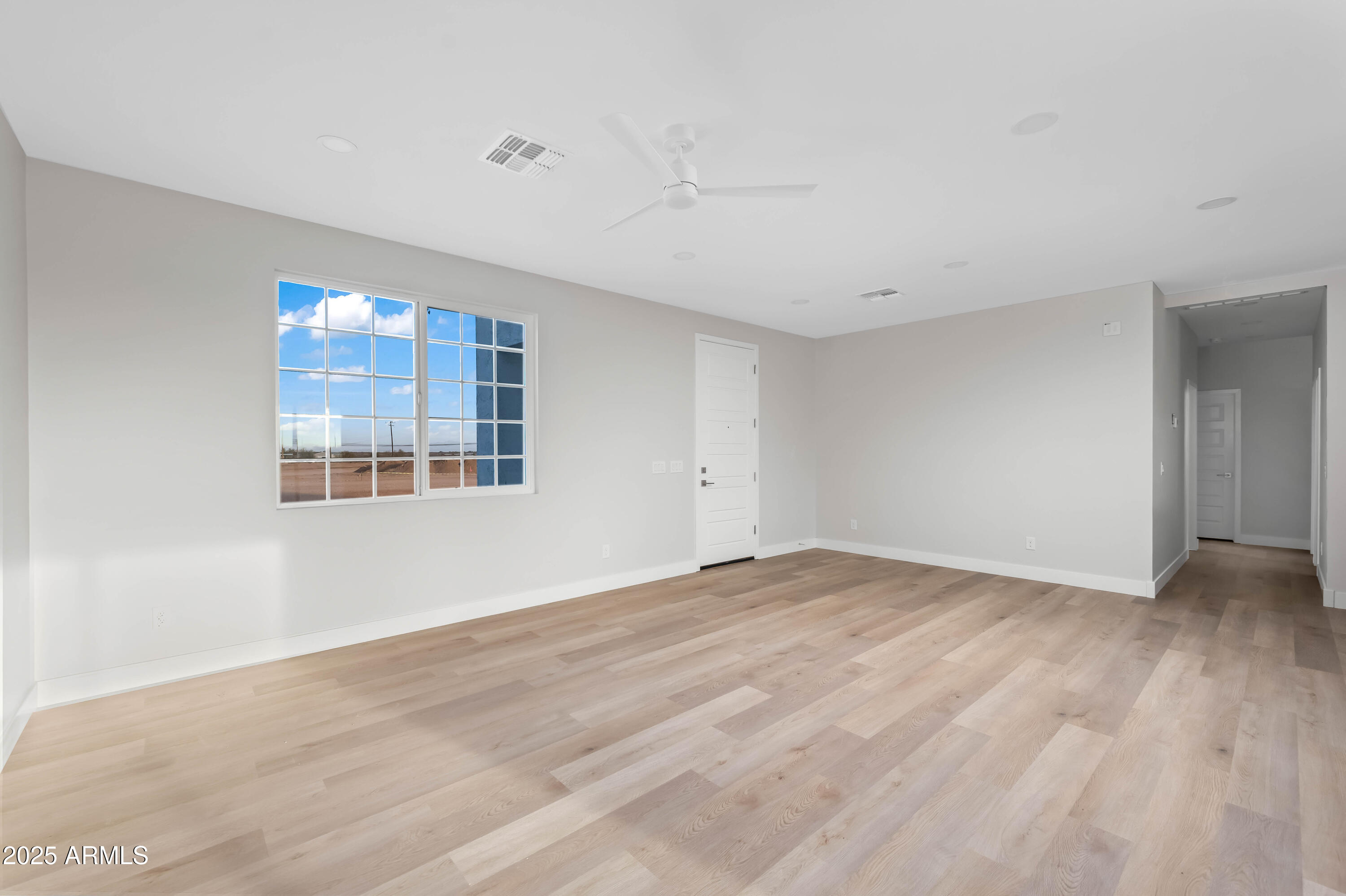 2103 Hassayampa Road Tonopah, AZ 85354 - Photo 31 of 37 a view of empty room with wooden floor and fan