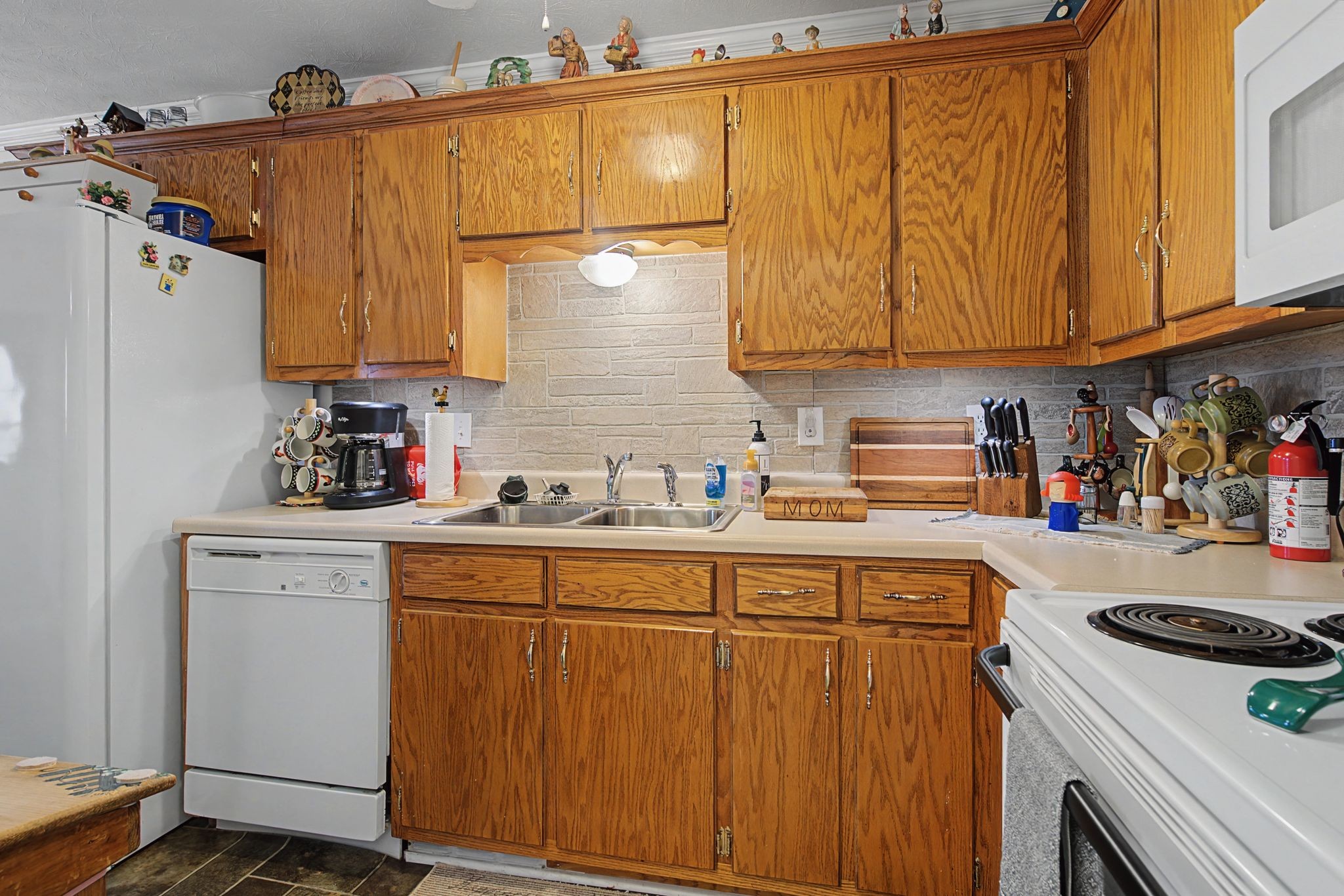 1075 Coker Ford Road Portland, TN 37148 - Photo 18 of 35 a kitchen with stainless steel appliances granite countertop a refrigerator and a sink