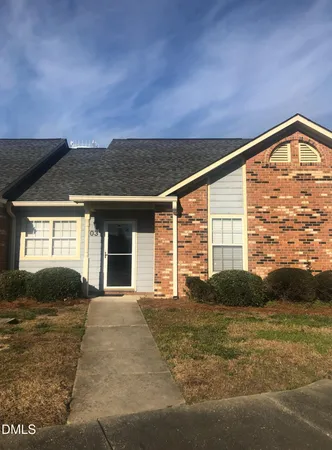 a view of yellow house with a yard