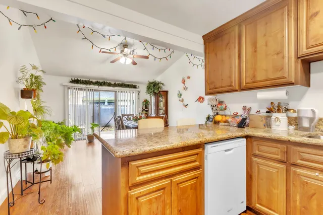 a kitchen with stainless steel appliances granite countertop sink stove and cabinets
