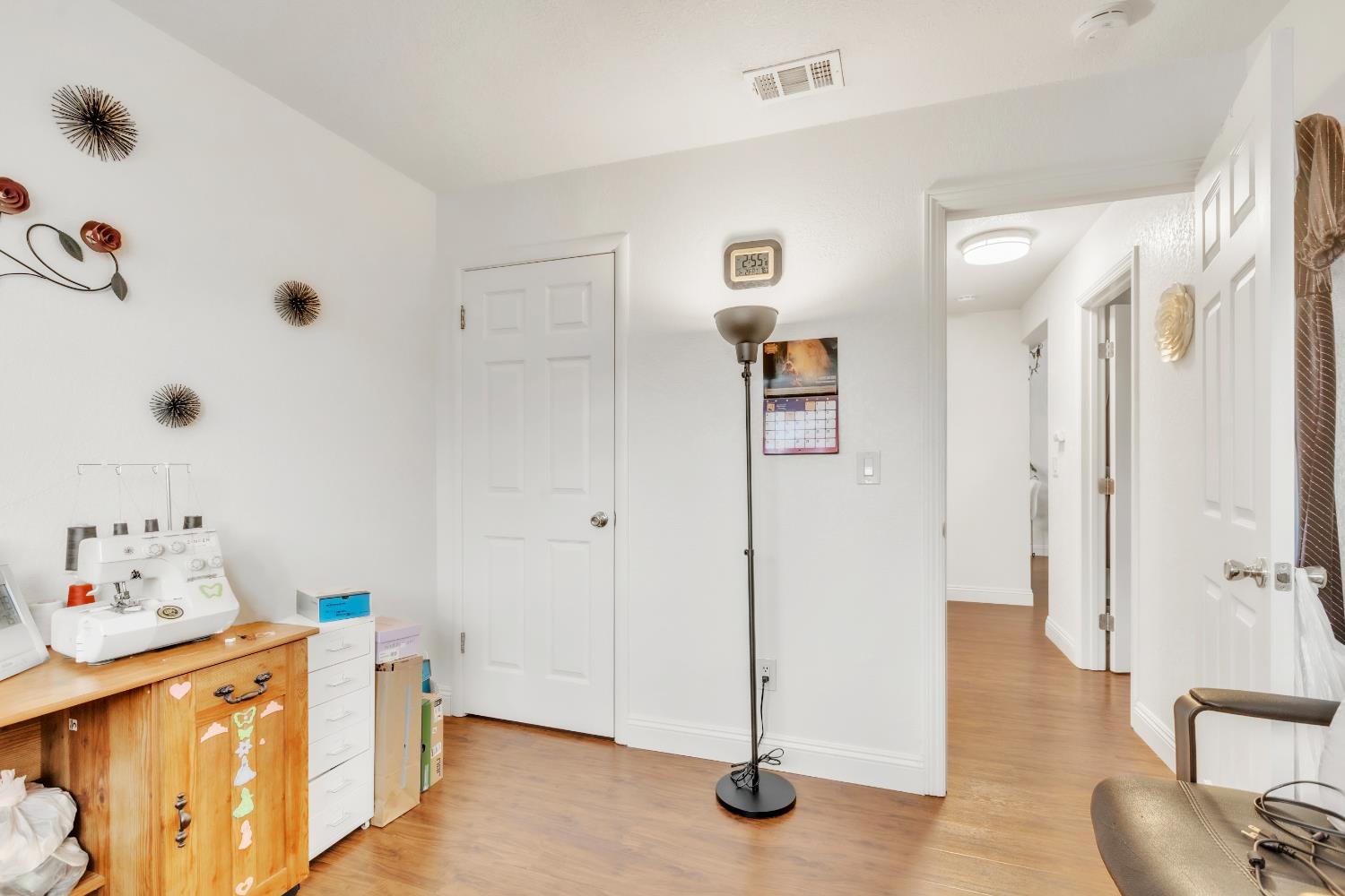 10973 Hirschfeld Way Rancho Cordova, CA 95670 - Photo 13 of 41 a view of a livingroom with wooden floor and a refrigerator