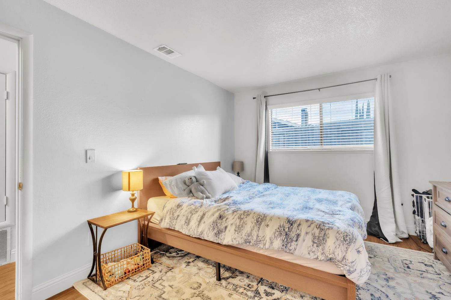 10973 Hirschfeld Way Rancho Cordova, CA 95670 - Photo 26 of 41 a bedroom with a bed and wooden floor