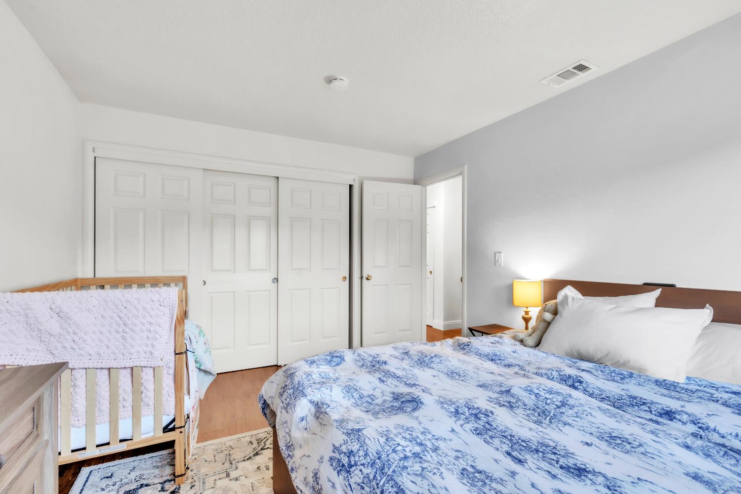 10973 Hirschfeld Way Rancho Cordova, CA 95670 - Photo 27 of 41 a bedroom with a bed and wooden floor