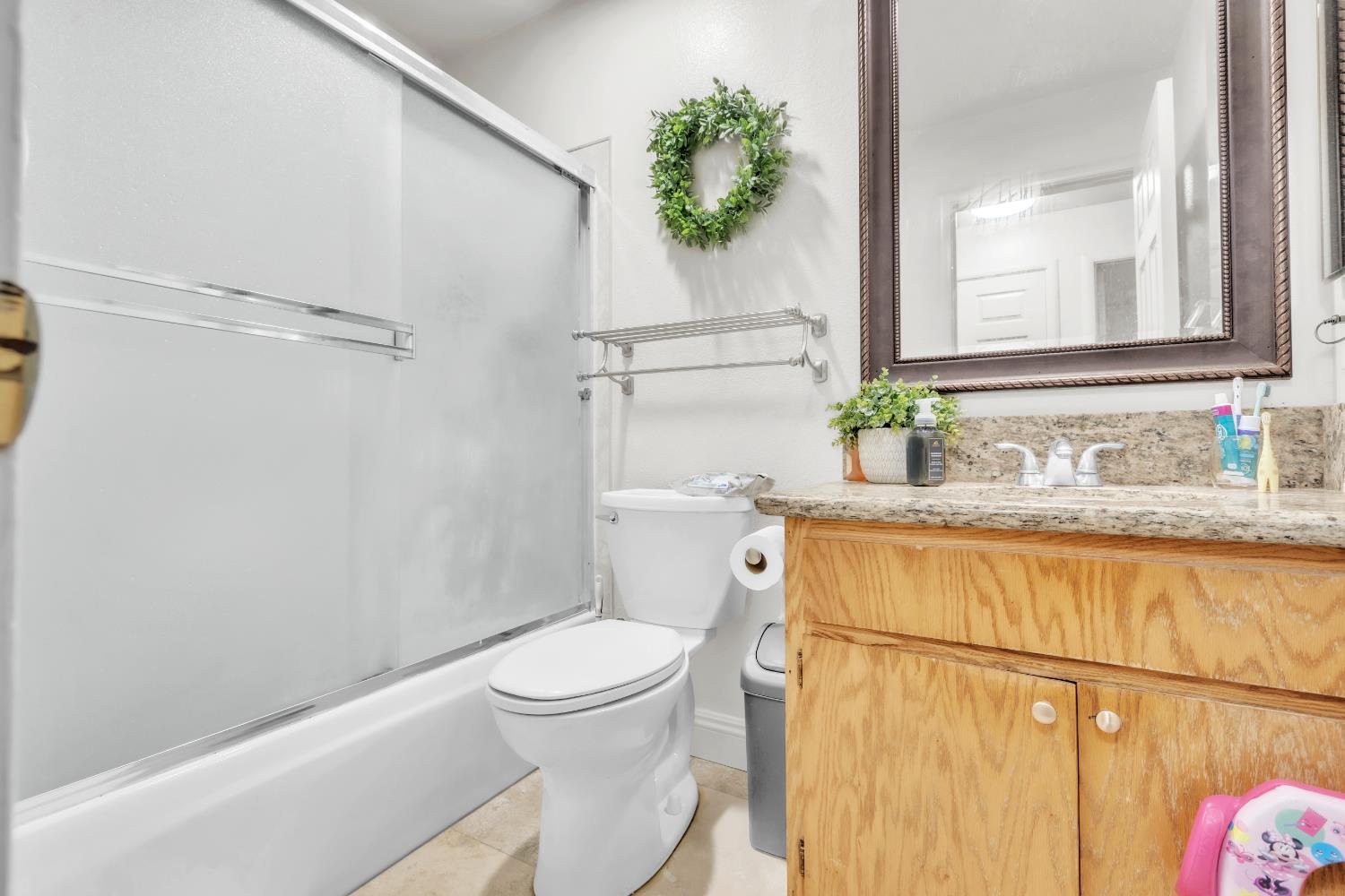 10973 Hirschfeld Way Rancho Cordova, CA 95670 - Photo 30 of 41 a bathroom with a granite countertop sink toilet and shower