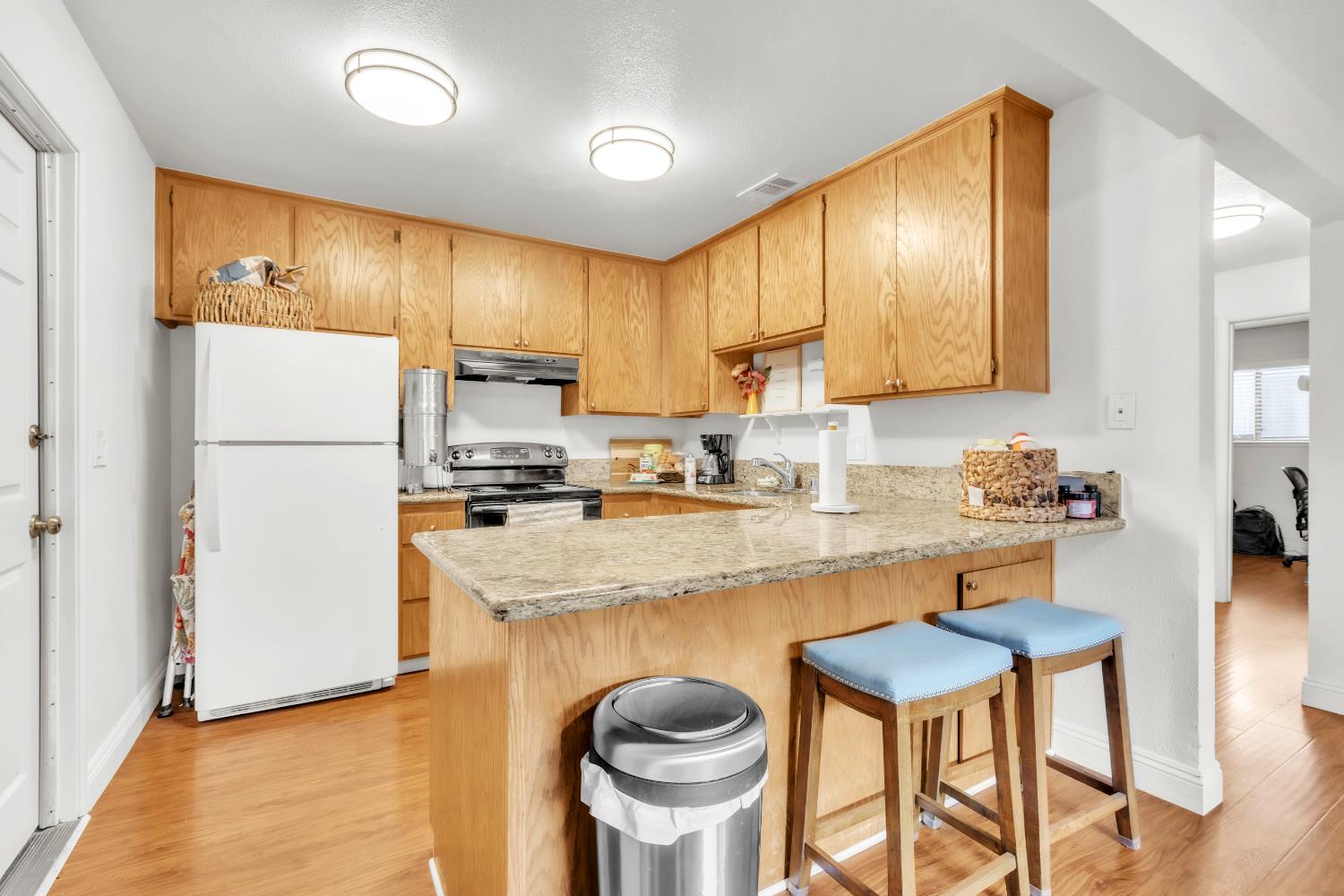 10973 Hirschfeld Way Rancho Cordova, CA 95670 - Photo 31 of 41 a kitchen with stainless steel appliances granite countertop a refrigerator a stove a sink dishwasher and white cabinets with wooden floor