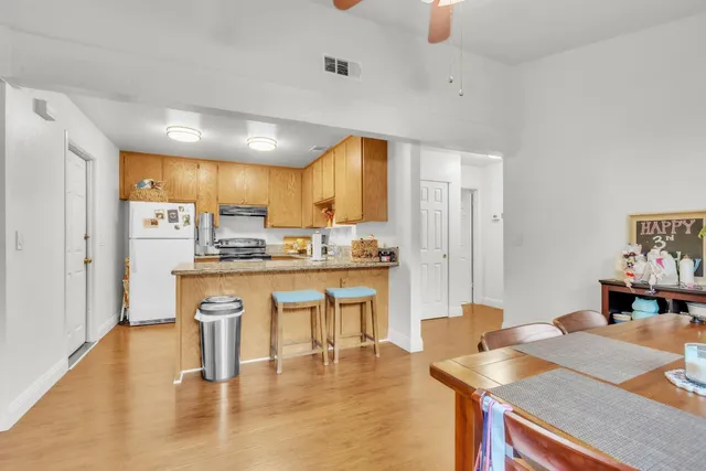 a kitchen with stainless steel appliances granite countertop a sink refrigerator and cabinets