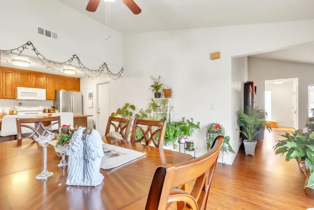 a view of a dining room with furniture and wooden floor