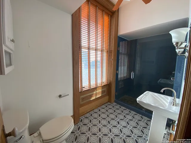 a bathroom with a toilet a sink and a shower