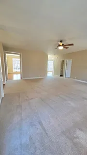 a large kitchen with stainless steel appliances wooden floors and view living room