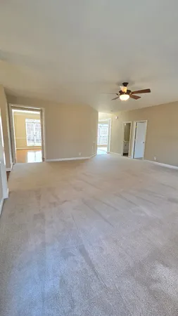 a large kitchen with stainless steel appliances wooden floors and view living room