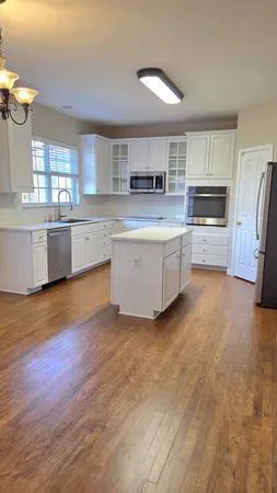 a kitchen with a refrigerator and a sink