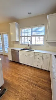 a bathroom with a granite countertop sink a toilet and shower