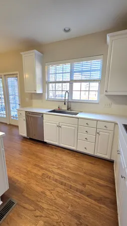 a bathroom with a granite countertop sink a toilet and shower