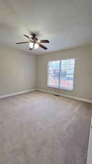 a view of a room with a ceiling fan