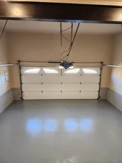 an empty room with a fireplace and windows