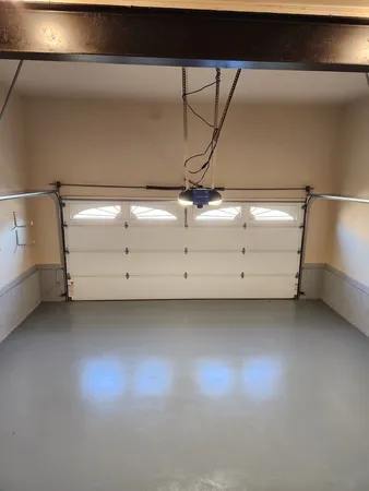 an empty room with a fireplace and windows