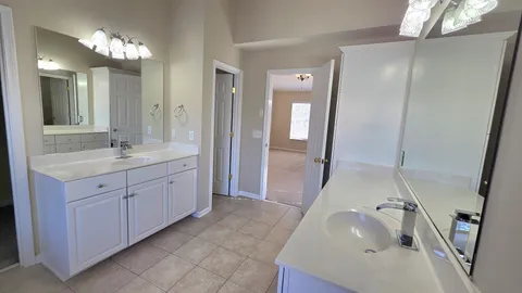 a view of a house with snow on the side of the road