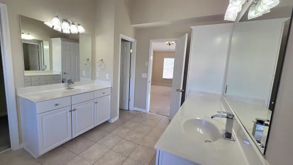 a view of a house with snow on the side of the road