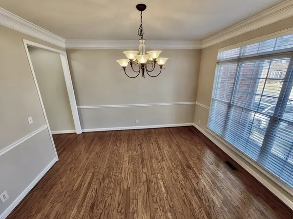 a view of a room with wooden floor and staircase