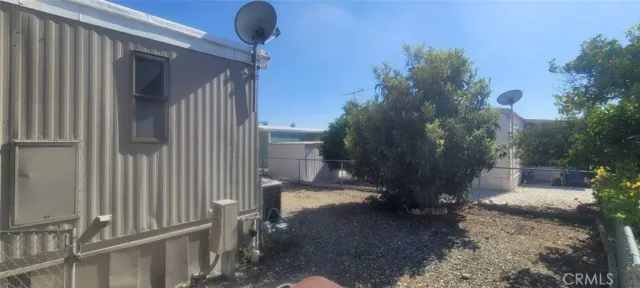 a view of a porch with furniture and a yard