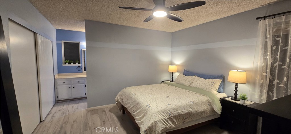 6830 Astoria Drive Riverside, CA 92503 - Photo 18 of 23 a bedroom with a bed and a lamp on table