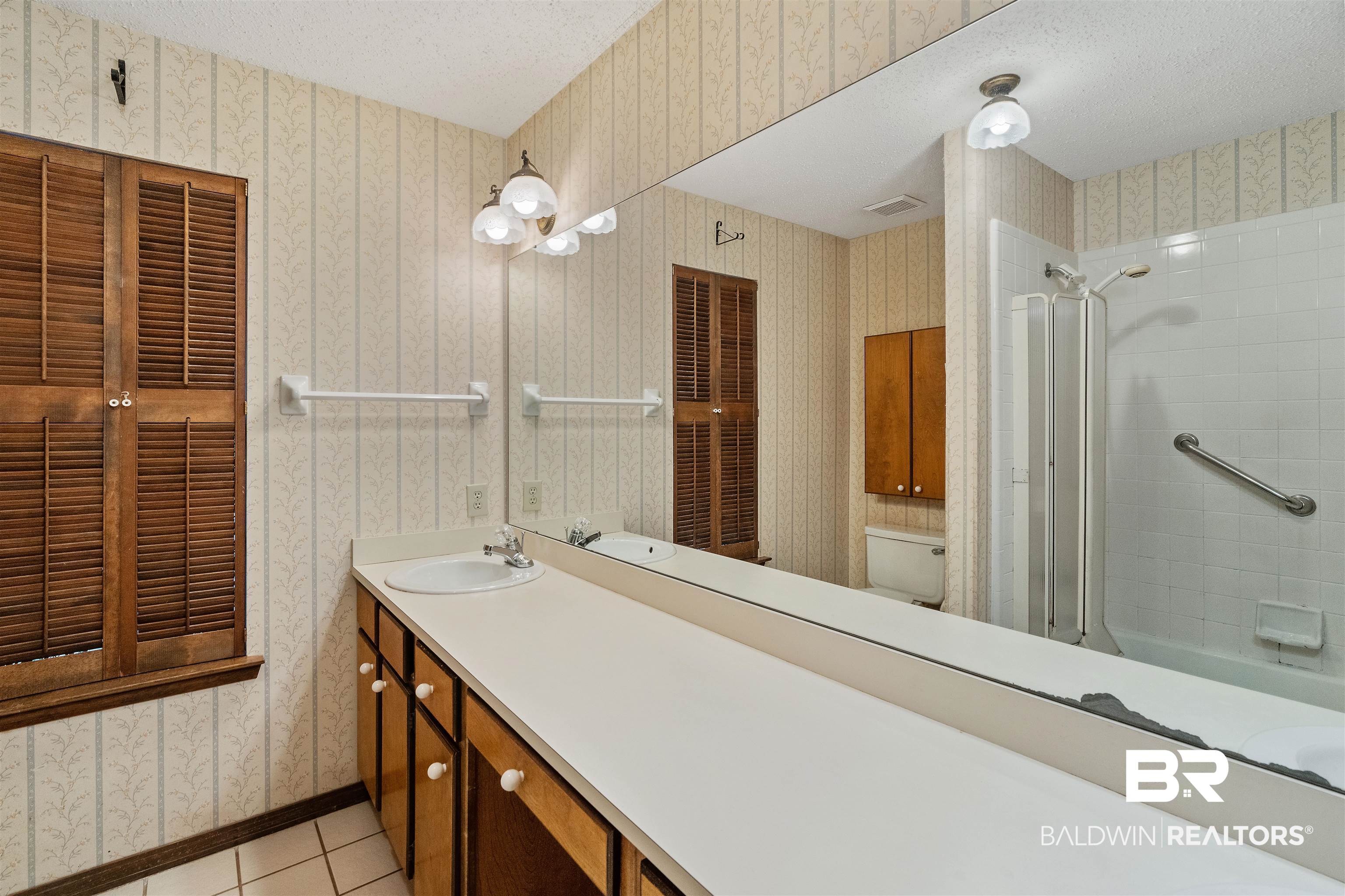 438 Ridgewood Drive Daphne, AL 36526 - Photo 13 of 28 Full bathroom featuring vanity, toilet, tiled shower / bath combo, a textured ceiling, and tile patterned flooring